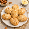 Veru Foods Almond Custard Cookies featuring golden-brown almond cookies with sliced almonds, served on a ceramic plate with almonds and custard